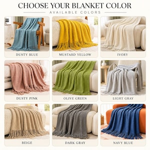 May include: A grid of nine textured knit blankets with fringe, labeled with colors: dusty blue, mustard yellow, ivory, dusty pink, olive green, light gray, beige, dark gray, and navy blue. The text at the top reads CHOOSE YOUR BLANKET COLOR.