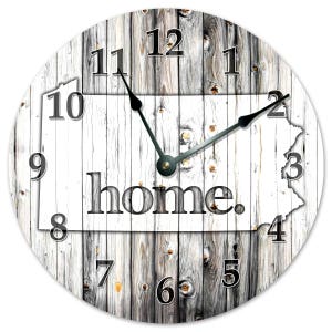 Miniature table clock to please rodeo lover or ranch person watchface. featuring a charm of a horse within a spur on a silver e.g.o