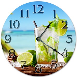 May include: Round wall clock featuring a refreshing mojito cocktail with lime slices, mint, and ice. The clock face has a beach scene background with blue numerals and black clock hands. The clock is a decorative item.