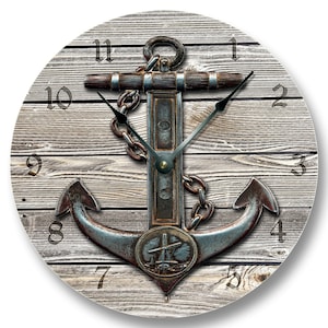 May include: Round wall clock with a nautical theme. The clock face features a weathered wood background with a large, detailed anchor design in shades of brown and blue. Black clock hands and numerals complete the design.