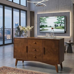 May include: A mid-century modern style wooden sideboard with three drawers and two cabinet doors. The sideboard is a warm brown color and has tapered legs. A clear glass vase with white flowers sits on top.