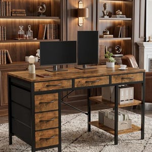 May include: A rustic-style desk with a brown wood-grain finish and black metal frame. The desk features multiple drawers, open shelving, and a spacious work surface. Two computer monitors sit on the desk, suggesting a home office setup.