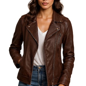 Könnte beinhalten: Braune Lederjacke mit asymmetrischem Reißverschluss und Reverskragen. Die Jacke hat mehrere Taschen und eine taillierte Passform. Die Person trägt ein weißes T-Shirt und blaue Jeans. Von JAB Leatherhub.