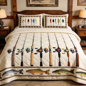 May include: Cream-coloured fishing-themed quilt set with a brown border featuring fish illustrations. The quilt displays fishing rods and two pillowcases with lure designs. The bed set is on a wooden bed frame.