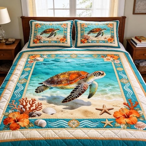 May include: A bedspread and two pillow shams featuring a sea turtle design. The quilt has a turquoise border and a central image of a turtle swimming in clear water. Coral, starfish, and orange hibiscus flowers decorate the edges.