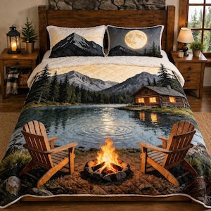 May include: A cozy cabin-themed quilt set featuring a mountain lake scene with a bonfire and two wooden chairs. The set includes a quilt and two pillow shams with mountain and moon designs. The bed is made of wood.