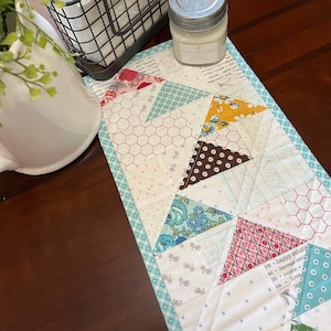 Scrappy skinny hand quilted runner