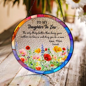May include: A circular stained glass window decoration with a chain for hanging. The design includes a floral border and the text "TO MY Daughter In Law" with a message from "Mom Sarah."