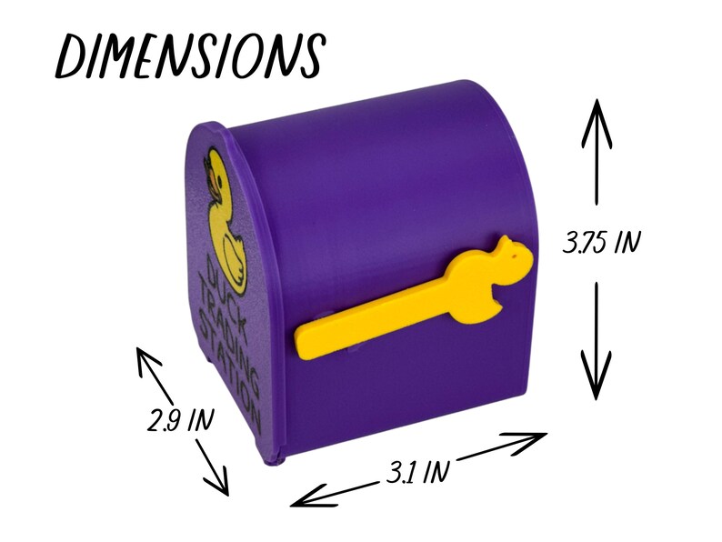 May include: A purple mailbox-shaped container with a yellow duck-shaped handle. The container has a yellow duck logo and the text "Duck Trading Station". Dimensions are 3.75 inches high, 2.9 inches wide, and 3.1 inches deep.