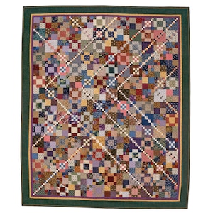 May include: A rectangular quilt featuring a complex patchwork design of numerous small squares in various colours and patterns. The quilt is framed by a thin yellow border, a purple inner border, and a wide dark green outer border.