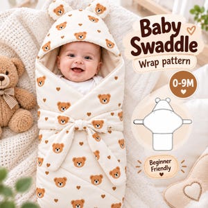 May include: A cream-colored baby swaddle wrap featuring a repeating brown bear and heart pattern, a hood with bear ears, and a tie closure. Text includes Baby Swaddle, Wrap pattern, 0-9M, and Beginner Friendly, with a line drawing of the wrap.