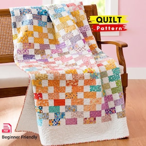 May include: A quilt featuring a patchwork design of small rectangular fabric pieces in various floral and geometric patterns in yellow, orange, pink, purple, blue, and green, with white borders and the text QUILT Pattern and Beginner Friendly.