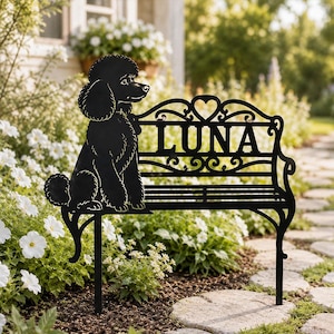 May include: A black metal garden stake featuring a silhouette of a poodle sitting on a decorative bench. The backrest of the bench includes a heart-shaped cutout and the name LUNA in bold, capital letters. The design has two pointed legs.