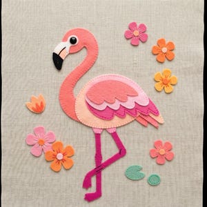 May include: A felt flamingo with a pink body, black beak, and pink legs, surrounded by felt flowers in shades of pink and orange. The flamingo is a whimsical, decorative item.