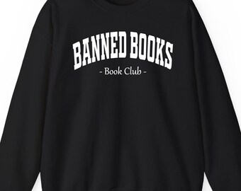 May include: Black sweatshirt with the text "BANNED BOOKS" in white, arched lettering above "- Book Club -" in a smaller font. The sweatshirt has a crew neck and long sleeves.