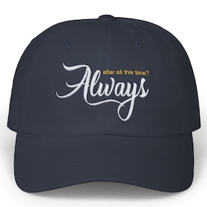 May include: Navy blue baseball cap with the word "Always" embroidered in white script. The phrase "after all this time?" is embroidered in yellow script above the word "Always".