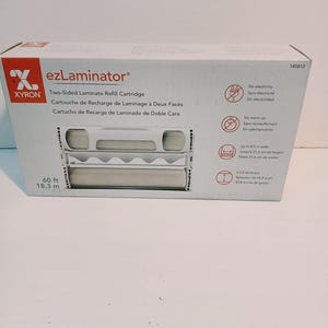 May include: A white rectangular box for a Xyron ezLaminator two-sided laminate refill cartridge. The packaging displays the product name, a 60 ft length, and icons indicating no electricity, no warm up, 8.5 inch width, and 2 mil thickness.