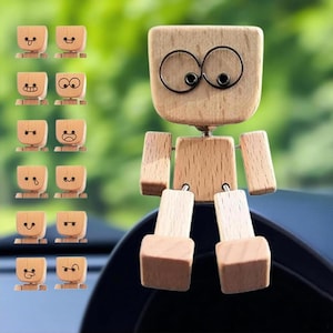 May include: A wooden robot-shaped car air vent clip with a large head and movable arms and legs. The robot has wire-framed eyes and a small wooden body. A set of small wooden face clips with different expressions are also included.