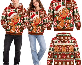 May include: A red and brown hooded sweatshirt featuring a gingerbread person wearing a Santa hat and holding a candy cane. The pattern includes Christmas trees, snowflakes, and peppermint candies. The text YOUR NAME is printed on the chest.