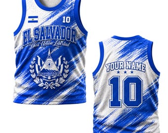 May include: A blue and white basketball jersey featuring the El Salvador flag, the text El Salvador Dios Union Libertad, and the number 10 on the front. The back displays the text Your Name above the number 10 with a brushstroke pattern.