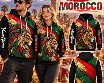 May include: Black hoodies featuring a lion head graphic with red, green, and gold diagonal stripes. The text 'Morocco' and 'Your Name' are printed on the sleeves and chest. The design includes a hood with white drawstrings and a front pocket.