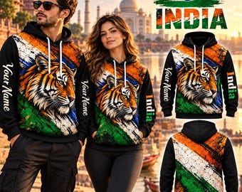 May include: Black hooded sweatshirts featuring a tiger head graphic, a distressed orange, white, and green flag pattern, white drawstrings, and the text "Your Name" and "India" printed on the sleeves and sides against a blurred background.