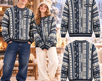 May include: A long-sleeved crew-neck jumper featuring a vertical striped pattern in shades of navy blue, grey, and white. The jumper includes a rectangular patch on the left chest with the text Your Name printed in a black script font.