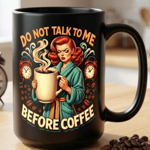 以下が含まれることがあります： 「DO NOT TALK TO ME BEFORE COFFEE」の文字が入った黒いセラミックコーヒーマグ。マグカップには、コーヒーカップを持ったバスローブ姿の女性のヴィンテージイラスト、目覚まし時計、コーヒー豆が描かれています。