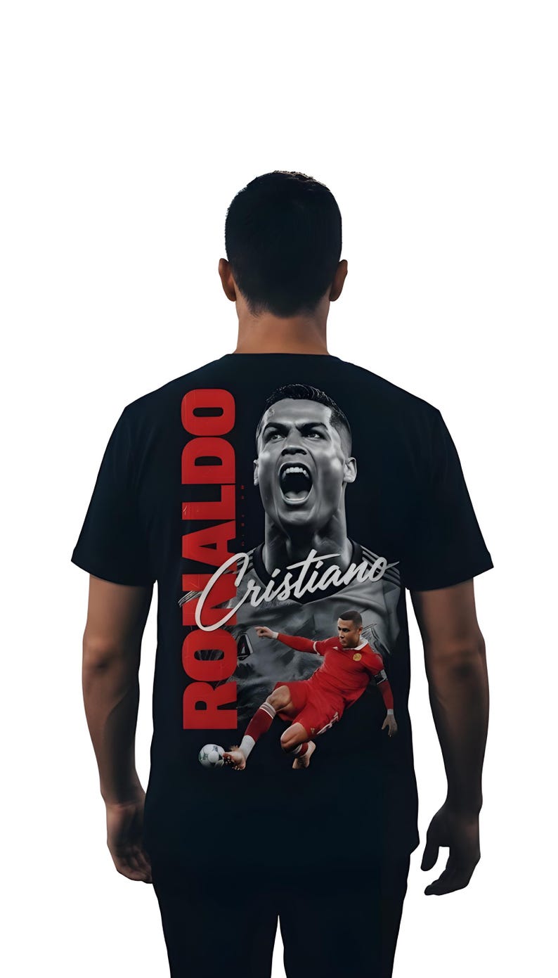May include: Black t-shirt featuring a large image of Cristiano Ronaldo. The design includes a portrait of Ronaldo with the name "Cristiano" in cursive and the word "RONALDO" in red vertical text. A second image shows Ronaldo in a red uniform.