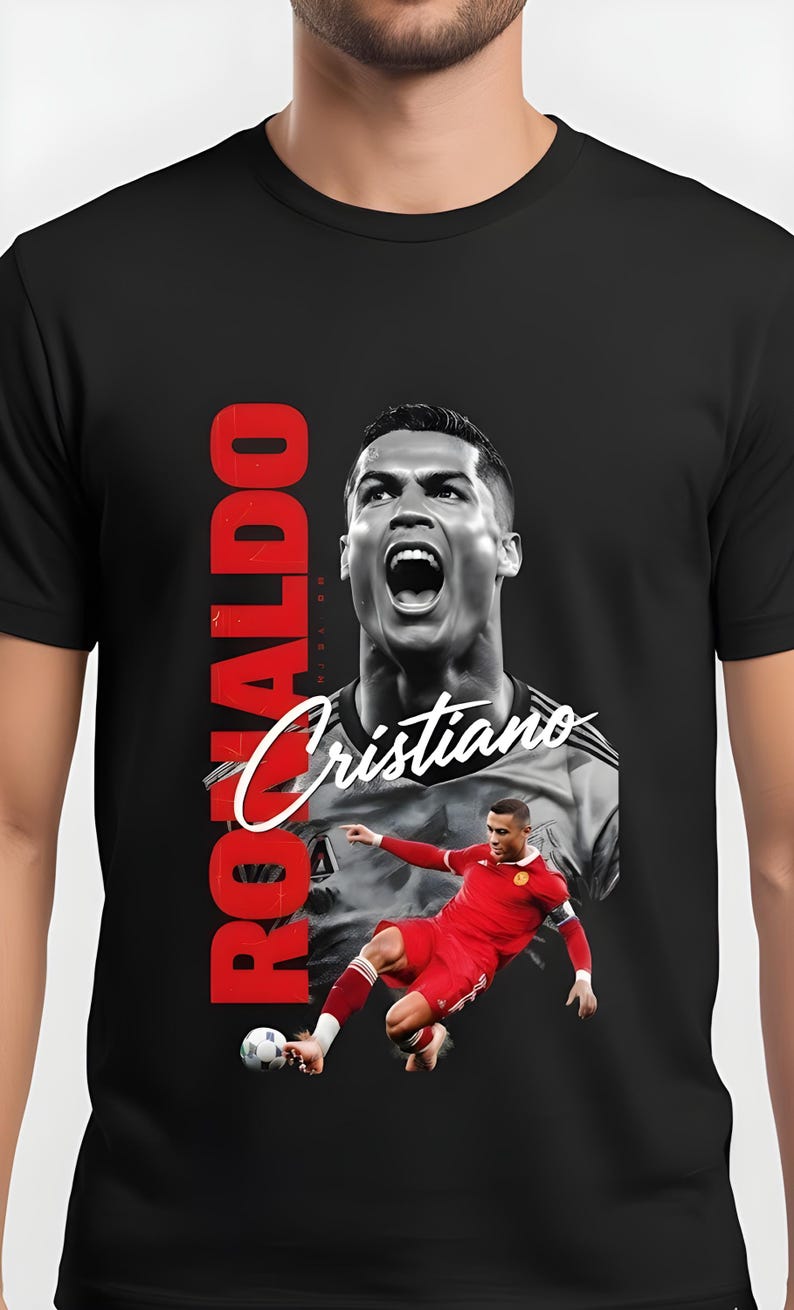 May include: Black t-shirt featuring a graphic of Cristiano Ronaldo in action. The design includes a large portrait and a smaller action shot, with the name "Ronaldo" in red vertical text and "Cristiano" in white script.