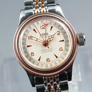 May include: A set of three ceramic mugs with a speckled, matte finish in cream, light brown, and dark brown. Each mug has a simple, minimalist design and a rounded handle.