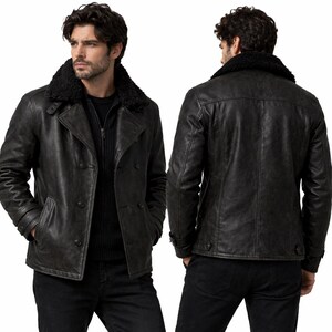 May include: A dark grey leather jacket with a black faux fur collar. The jacket features a double-breasted design with two rows of buttons and a front zip. The image shows the front and back of the jacket.