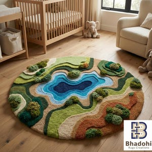May include: A round, landscape-themed rug with a lake design. The rug features a central blue lake surrounded by green, tan, and brown terrain, with tufted tree-like accents. The rug is placed on a wooden floor in a nursery setting.
