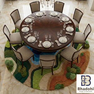 May include: An overhead view of a formal dining room setup. A large, round, dark wood table is set for a meal with eight chairs. The table sits on a colorful, round rug with a landscape design. A chandelier hangs above the table.