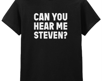 May include: Black t-shirt with the white text "CAN YOU HEAR ME STEVEN?" printed across the front. The shirt has short sleeves and a crew neck. The text is in a bold, sans-serif font.