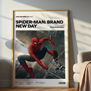 May include: A framed vertical poster titled Spider-Man: Brand New Day, directed by Destin Daniel Cretton, featuring a central image of Spider-Man in a red and blue suit crouching above a city street, with the year 2026 printed at the bottom.