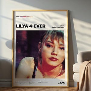 May include: A rectangular movie poster for the film LILYA 4-EVER, featuring a portrait of a young person with blonde hair and dark red lipstick. The poster includes the title, director Lukas Moodysson, the year 2002, and a color palette bar.