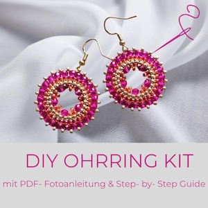 Puede incluir: Un par de pendientes circulares de cuentas con cristales de color rosa intenso y naranja con ganchos dorados. El texto dice DIY OHRRING KIT mit PDF- Fotoanleitung & Step- by- Step Guide, junto a un icono de aguja e hilo rosa.