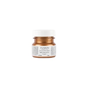 May include: A small bottle of Fusion Mineral Paint in the colour Copper. The bottle is 1 oz (37 ml) and is labelled with the Fusion logo and the words "paint beautiful" and "metallics".