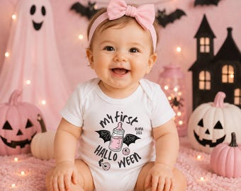 May include: A white short-sleeved baby bodysuit featuring a graphic of a baby bottle with bat wings and the text My First Halloween, along with the name Olivia and the year 2026. A light pink bow headband is worn on the head.