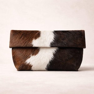 Handcrafted large leather clutch bag made from genuine tri-color hair-on-hide cowhide, featuring a modern foldover design in natural brown, black, and white tones for a western boho aesthetic. gift for her, gift for sister, gift for mother, personalized gift, custom handmade gift, trendy fashion