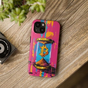 May include: A pink phone case with a colorful paint splatter design. The case features a gold hourglass with a Bitcoin symbol inside.