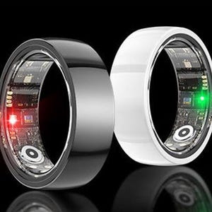 May include: Two smart rings, one black and one white, are displayed against a black background. The rings have a sleek, modern design with a visible circuit board and embedded lights. The black ring has a red light, and the white ring has a green light.