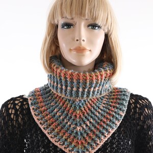 May include: A crocheted cowl with a triangular shape and a ribbed texture. The cowl is made with a multi-colored yarn in shades of blue, green, orange, and pink.