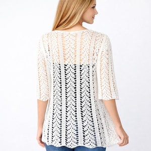 Puede incluir: Rebeca de crochet color crema con tejido abierto y mangas tres cuartos. La espalda presenta un dise&ntilde;o vertical calado. La rebeca es ligera y parece estar hecha de un material suave y transpirable, adecuado para superponer capas.