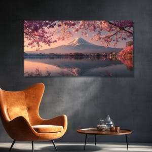 May include: A large canvas print depicts a serene Japanese landscape. Mount Fuji is visible in the distance, reflected in the calm water. Cherry blossoms frame the scene with pink hues, creating a tranquil and picturesque view.
