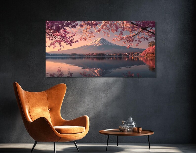 May include: A large canvas print depicts a serene Japanese landscape. Mount Fuji is visible in the distance, reflected in the calm water. Cherry blossoms frame the scene with pink hues, creating a tranquil and picturesque view.