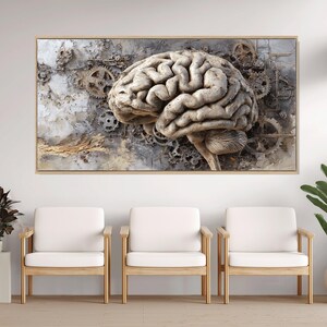 Könnte beinhalten: Ein gerahmtes Kunstwerk mit einer detaillierten, strukturierten Darstellung eines menschlichen Gehirns, integriert mit Zahnrädern und mechanischen Elementen. Die Farbpalette ist überwiegend neutral, mit Grautönen, Beige und Braun. Das Kunstwerk wird über drei Holzstühlen mit weißen Kissen ausgestellt.