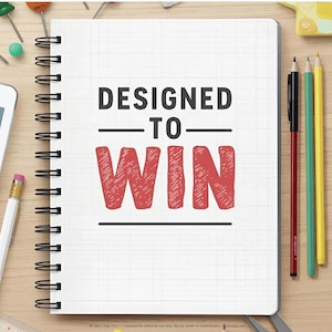 May include: A white spiral-bound notebook with a grid pattern on the cover featuring the black text "DESIGNED TO" above the large red hand-drawn style text "WIN". The notebook is surrounded by office supplies including pencils, a calculator, and a tablet.