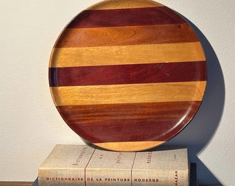 Handcrafted striped wooden serving tray or plate made from a mix of hardwoods. 10 inches.